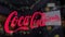 Coca-Cola logo on the glass against blurred business center. Editorial 3D rendering