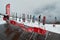 Coca Cola sun chairs on a piste apes-ski lodge terrace deck with ski/snowboard equipment in front of it