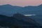 Cocentaina Castle in Spain on top of a hill with mountains and a sunset sky in the background