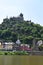 Cochem, Germany - 06 17 2021: Reichsburg above the colorful old town houses and city walls tower