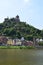 Cochem, Germany - 06 17 2021: Reichsburg above the thin waterfront at the city walls tower