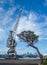 Cockatoo island Sydney, Australia, large industrial crane with old tree on dock of historical maritime ship yard