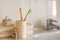 Cockleshell, Bath white cotton towels and bamboo toothbrushes on Blurred bathroom interior background with sink and faucet