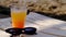 Cocktail drink on the beach. Sunglasses, holiday, relaxed. Close up glass of smoothie juice and sunglasses on sand at