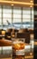 Cocktail glass on airport lounge table,background of large windows,airplanes and sunset outside