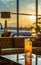 Cocktail glass on airport lounge table,background of large windows,airplanes and sunset outside