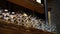 Cocktail glasses lines up on wood loft style bar shelves