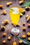 Cocktail with physalis in glass on wooden background