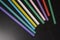 Cocktail plastic tubes for alcohol and beverages, colored on a reflective black surface. Things for the hotel and bar business, re