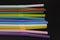 Cocktail plastic tubes for alcohol and beverages, colored on a reflective black surface. Things for the hotel and bar business, re