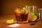 Cocktail of rum and cola ice cubes and lime in a glass goblet on a dark brown background. Strong alcoholic drink.