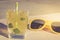 cocktail and yellow sunglasses/cocktail and yellow sunglasses on a light wooden background, selective focus