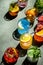 Cocktails set on rusty green bar counter, top view. Mixology concept. Assortment of colorful strong and low alcohol drinks for