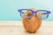 A cocnut wearing 3D glasses on blue background. Summer and trave concept