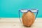 A cocnut wearing 3D glasses on blue background. Summer and travel concept