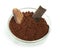 Cocoa bean, cocoa powder in bowls and piece of chocolate