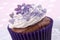 Cocoa cupcake with lilac flower