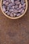 Cocoa flat lay  concept with raw cocoa beans in woooden bowl  on iron  background