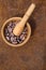 Cocoa flat lay  concept with raw cocoa beans in woooden bowl and spoon on iron  background