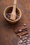 Cocoa flat lay  concept with raw cocoa beans in woooden bowl ,  twig of cinnamon on iron  background