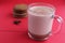 Cocoa hot chocolate in a glass mug on a red background with room for text copyspace and liver on hellish plan