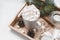 Cocoa with  marshmallows, fir branch, cones, candle, snowflakes, gift boxes with white ribbons on a tray on a light