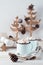 Cocoa and marshmallows in mugs, Christmas craft gifts and Christmas trees on a white wooden table. Eco-friendly holiday. Vertical
