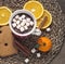 Cocoa with marshmallows, orange slices, cinnamon and gingerbread cookies