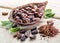 Cocoa powder and cocao beans on a wooden table.