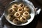 Cococnut cookies, with cream cheese and almonds in plate on table with teatowel. Home kitchen sweets, baked.