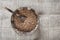 Coconut bowl with raw buckwheat on a linen cloth