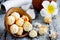 Coconut candies from coconut chips in half coconut shell on wooden table with plumeria