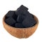 Coconut coal in half a coconut shell on a white background. Coconut charcoal cubes for hookah close-up.