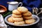 coconut cookies stacked on a ceramic dish with a spoon