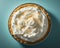 a coconut cream pie with whipped cream on top