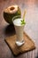 Coconut flavoured plain white lassi OR milk shake garnished with a coconut and mint leaves.