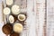 Coconut, glass of coconut milk and bowl with coconut flakes on a white wooden background. Top view. With copy space