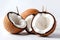 Coconut halves with shredded coconut on a white background. Generative AI
