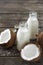 Coconut kefir in bottles on wooden table