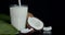 Coconut milk flows in glass.