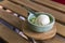 Coconut milk ice cream in bowl painted turquoise on wood slat -