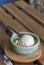 Coconut milk ice cream in bowl painted turquoise on wood slat -