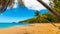 Coconut palm trees leaning over La Perle beach in Guadeloupe