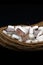 Coconut Pieces place in Twisted Coir Ropes. on Isolated Black Background. Conceptual Photography,