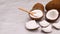 Coconut powder and wooden spoon in coconuts shell and sliced coconut. Stop motion