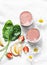 Coconut probiotic yogurt, spinach, apple, strawberry detox smoothie on a light background, top view. Healthy diet food concept.