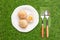 Coconut rice cakes, Crisp on the outside and soft, Topped with the carrot on a white plate with fork, spoon, and green background