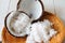 Coconut shell and Freshly grated coconut on bamboo tray