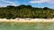 Coconut trees on a white beach. Caramoan Islands, Philippines.