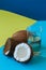 Coconut water, whole coconuts on a duo tone background. Coconut
